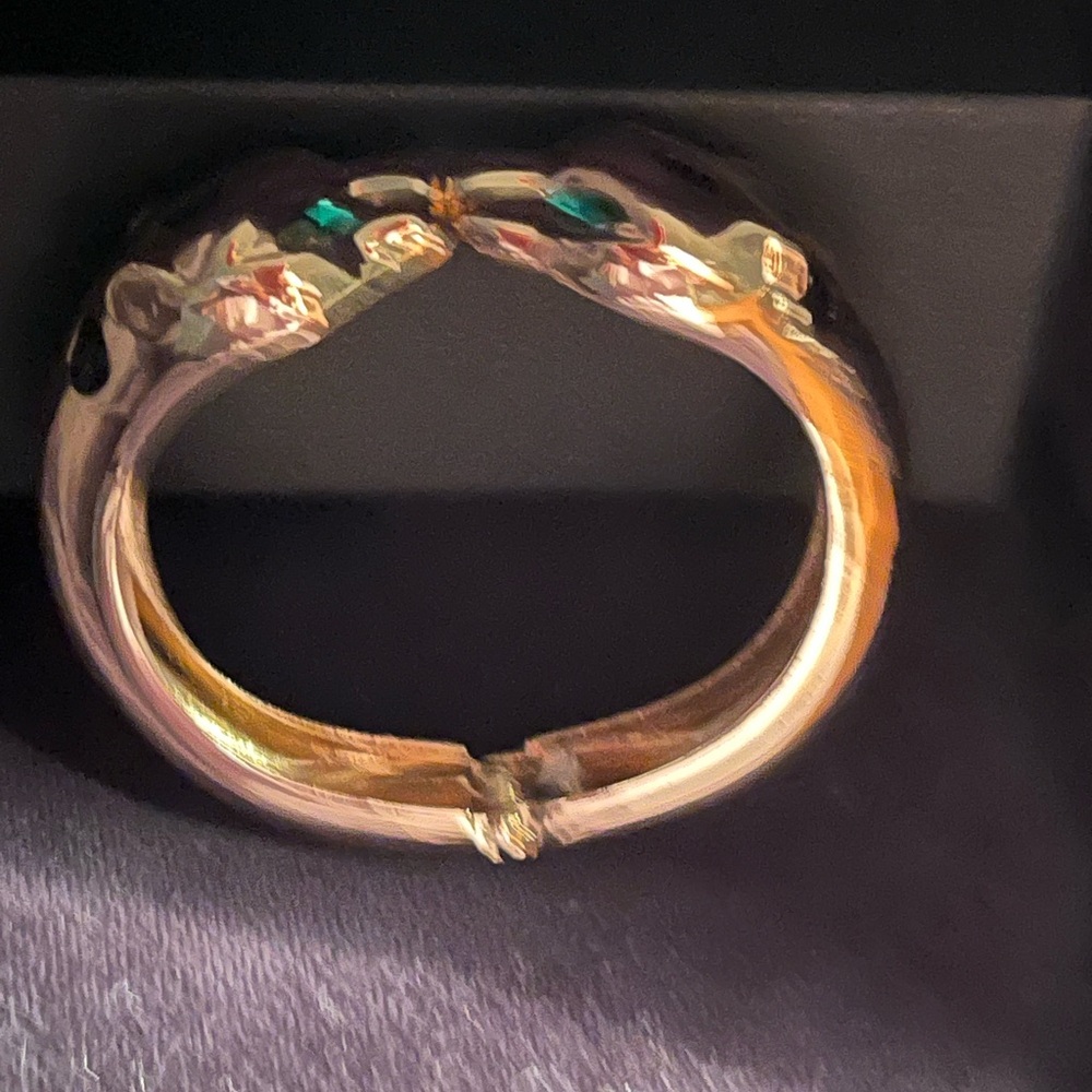 Pather bangle bracelet gold with emerald eyes designer inspired sleek elegance.